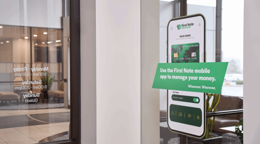 Window graphic advertising a banking app inside an office